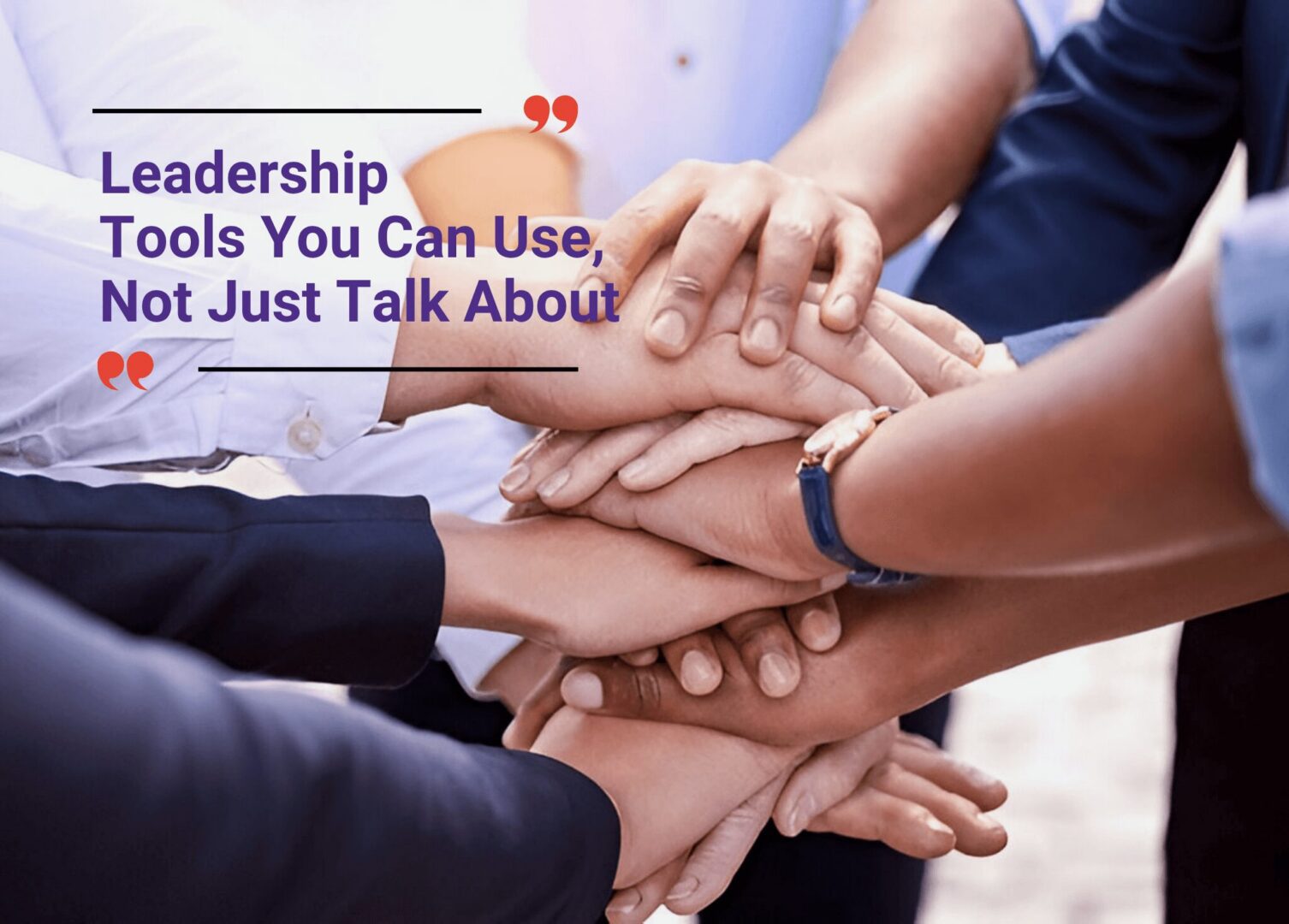 Team members stacking hands as a symbol of leadership and unity.