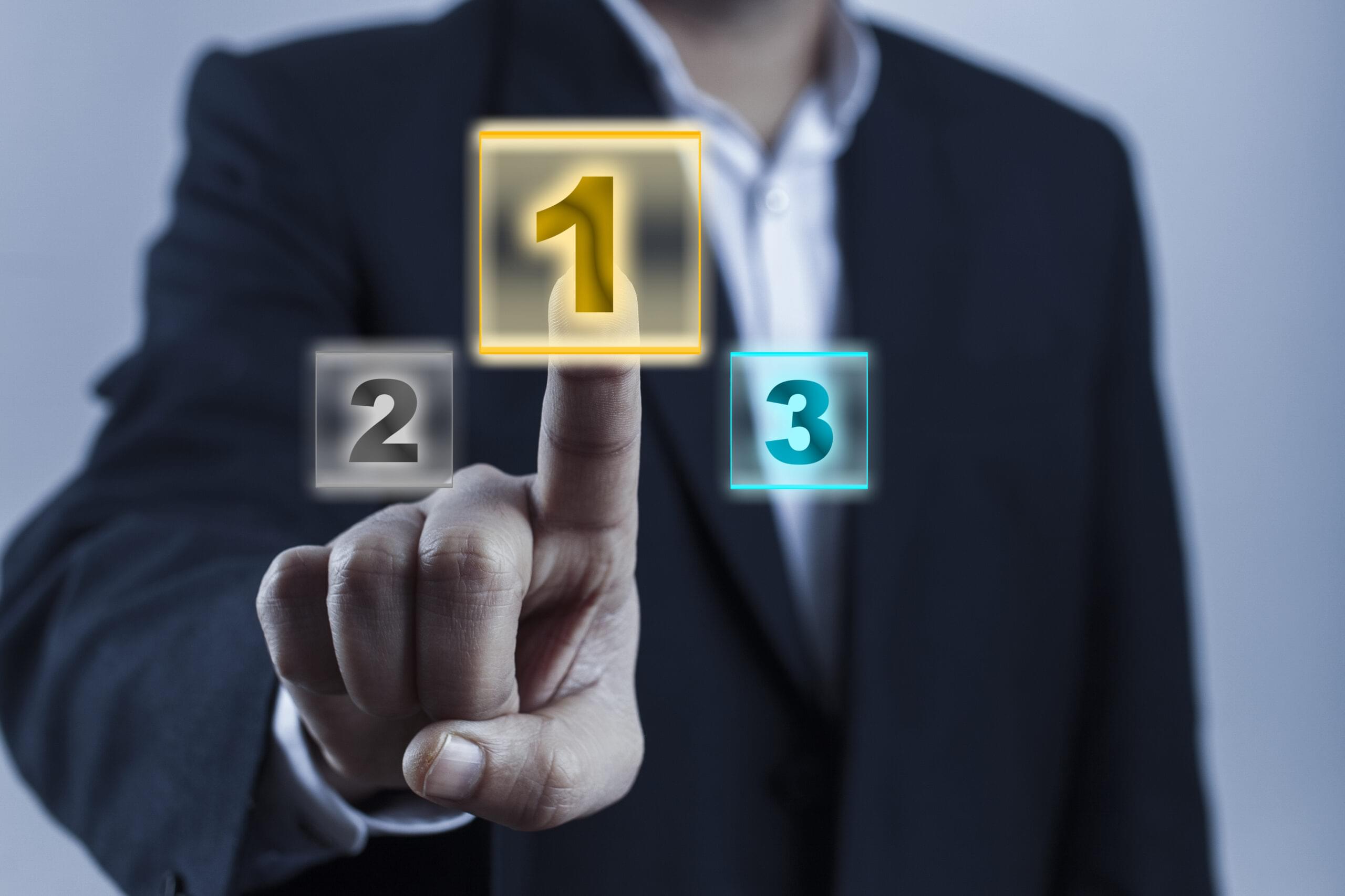 Businessperson pressing a glowing number one button on a virtual interface.