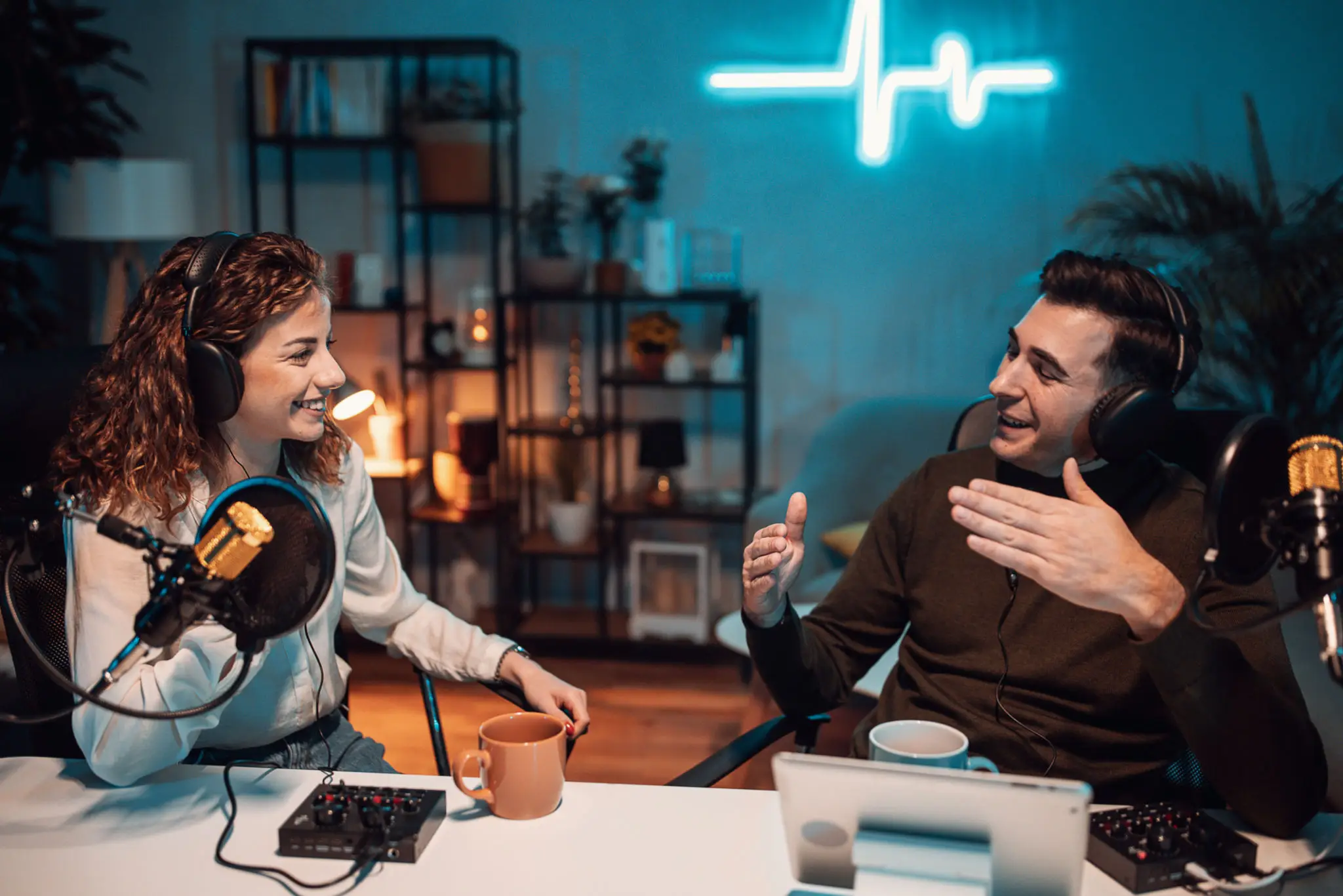Two people recording a podcast together, talking.